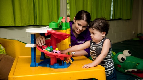 Woman and child playing with car toys