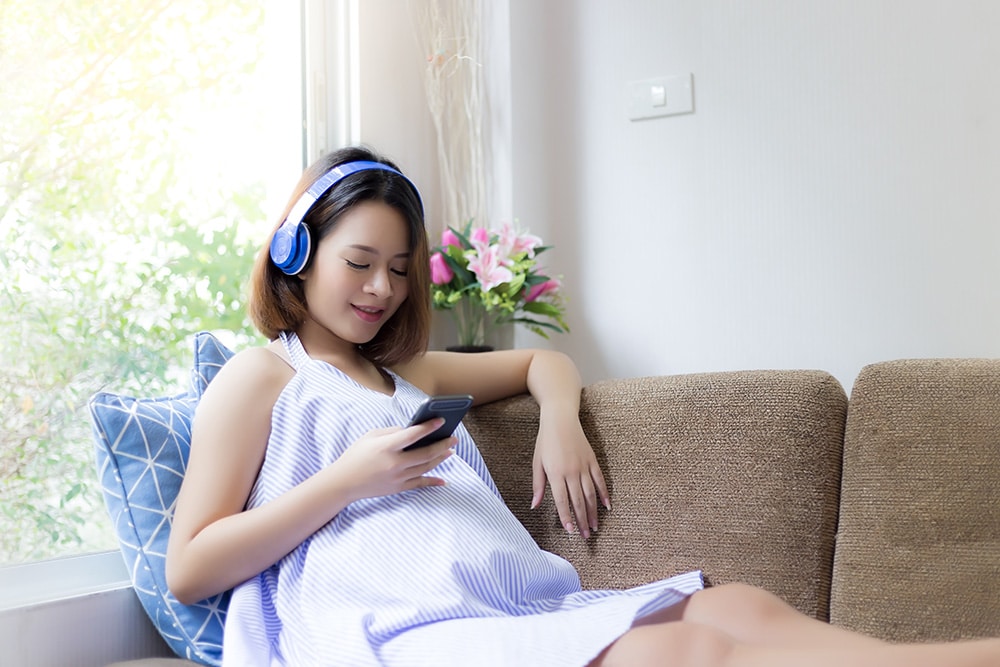 Adolescent listens to music as part of her music therapy