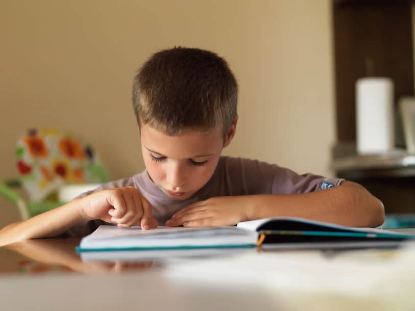 Boy with dyslexia having a hard time reading