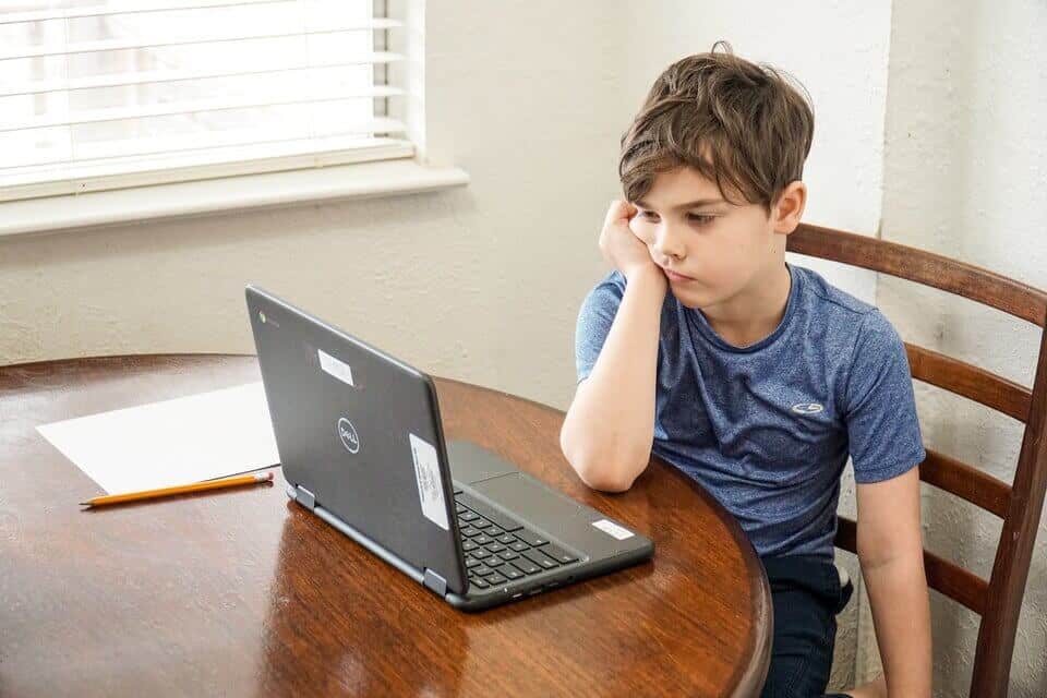 boy with oppositional defiant disorder sitting in front of laptop