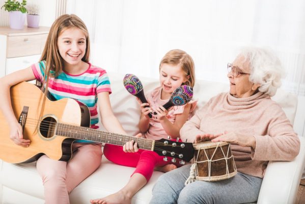 Children and grandmother are making music together